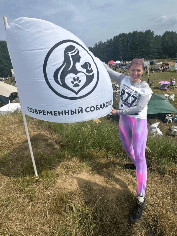Анна Тимофеева с флагом клуба Современный собаковод